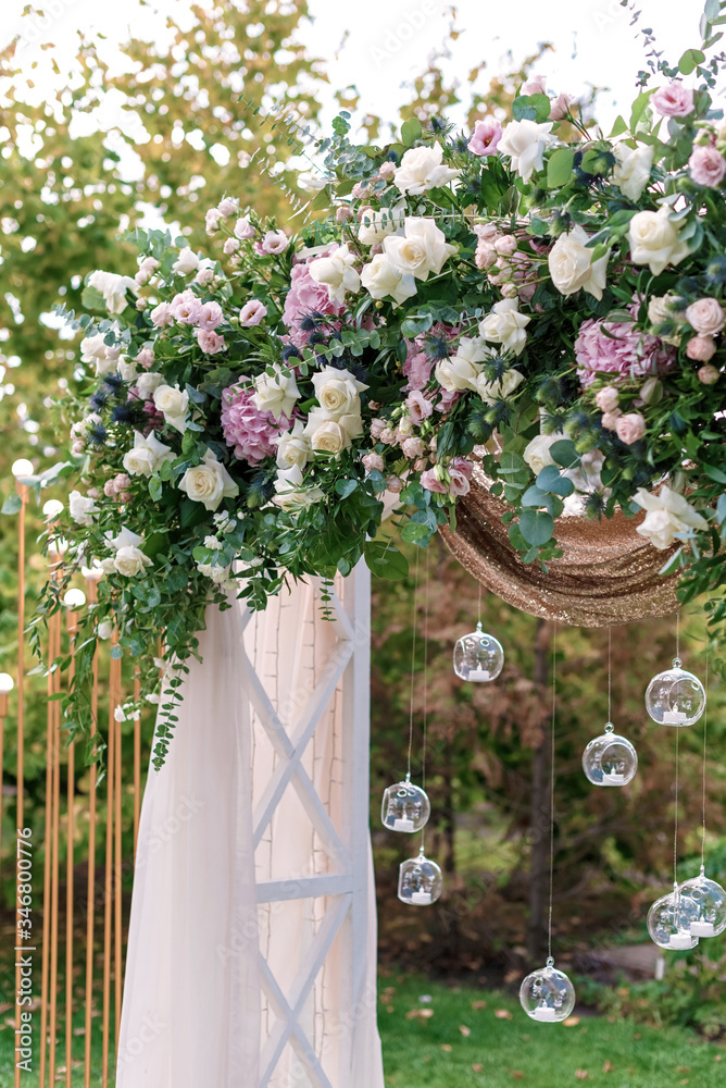 Poster arch for the wedding ceremony, decorated with cloth and flowers