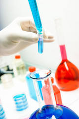 scientist analyzing virus in laboratory covid 19 blood and chemical reagent tube on hand coronavirus vaccine research