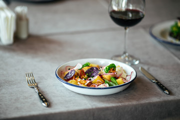 Salad fried cheese vegetables glass of red wine