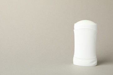 Body deodorant on gray background, blank space for text