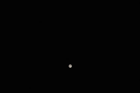 night moon shines in the black sky