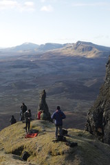Fototapeta premium Hikers congregate on a mountain peak. 