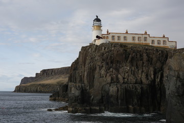 Fototapeta na wymiar A traditional lighthouse on a cliff. 