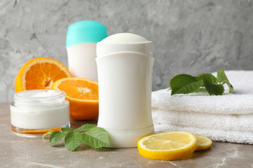 Composition with body deodorants on gray background, space for text
