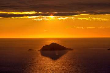 Naklejka na ściany i meble Sunset golden hour on the island of Tino in the Gulf of La Spezia Italy, from Montemarcello