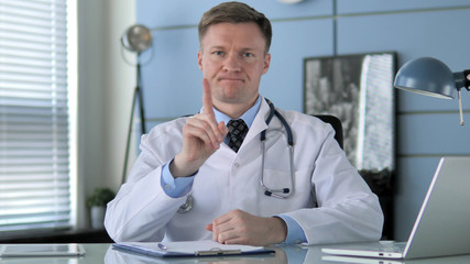 No, Doctor Restricting Patient by Waving Finger