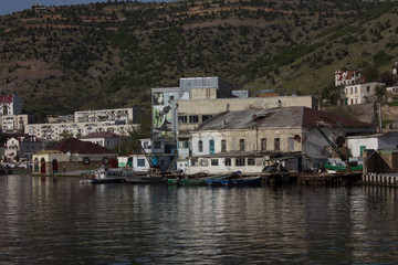 Crimea, Sevastopol, Balaklava district - 03/05/2017 : view of the houses from the bay on a foggy morning.