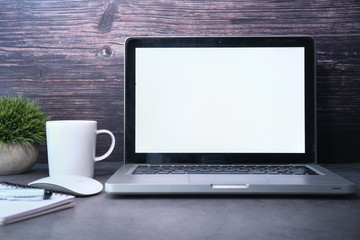 Laptop with white screen on office table