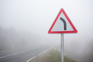 Warning road sign steep turn