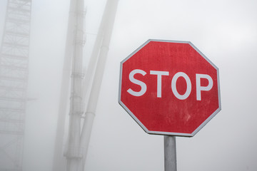 Stop road sign in fog