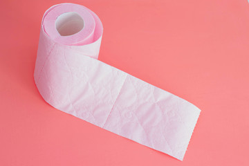 Pink soft toilet paper on a pink background. Delicate hygiene