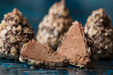 Delicious chocolates in waffle crumbs cut into slices, in half, close-up macro, side view and top view