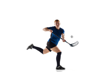Fototapeta na wymiar Floorball female player isolated on white studio background. Action and motion, movement, healthy lifestyle and overcoming concept. Young caucasian woman in sportwear training, practicing the game.
