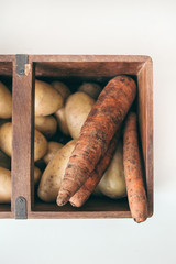 potatoes and carrots in the wooden box
