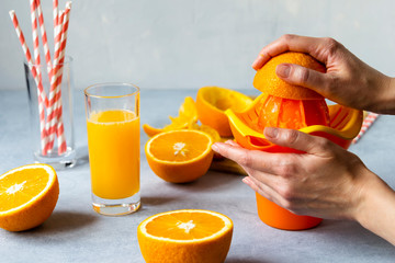 woman make orange juice home. female hands. haelthy food