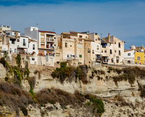 Fototapeta na wymiar Residential buildings on the edge of high rock in Sorbas, Spain.