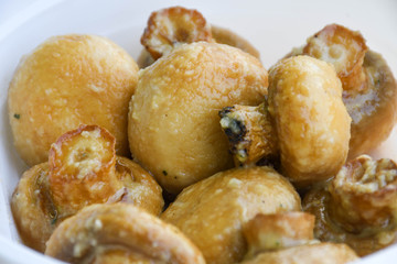 Sauteed mushrooms with garlic and parsley served during catering event.