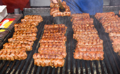 Chef grilling meat during cookout picnic or food event. Meat mix variety, Labour Day, 1 Mai