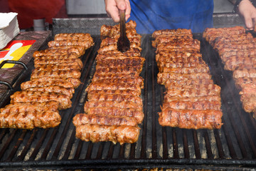 Chef grilling meat during cookout picnic or food event. Meat mix variety, Labour Day, 1 Mai