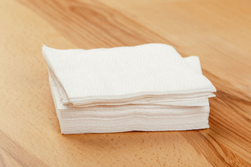 white paper napkin or tissue on the wooden table background.