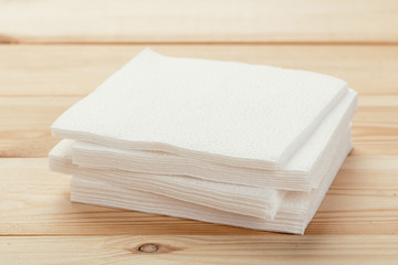 white paper napkin or tissue on the wooden table background.