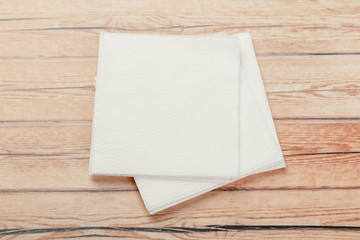 white paper napkin or tissue on the wooden table background.