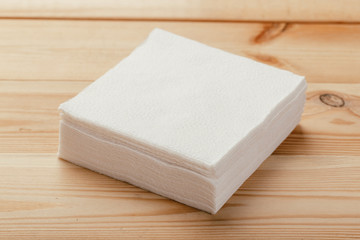 white paper napkin or tissue on the wooden table background.