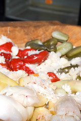 Assorted mix of pickles in sunlight during food festival. Pickled vegetables like red peppers