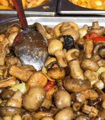 Sauteed mushrooms with garlic and parsley served during catering event.
