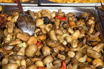 Sauteed mushrooms with garlic and parsley served during catering event.