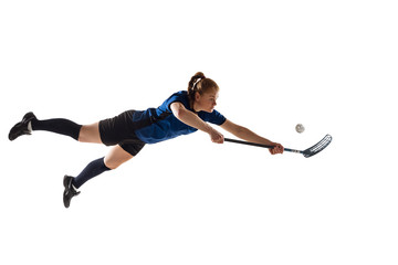 Floorball female player isolated on white studio background. Action and motion, movement, healthy lifestyle and overcoming concept. Young caucasian woman in sportwear training, practicing the game.