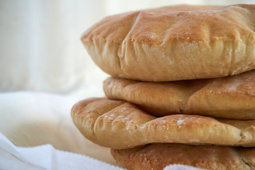 A stack of pita bread on a white background - fresh baked gluten-free pita bread 