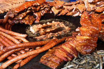 Chef grilling meat during cookout picnic or food event. Meat mix variety, Labour Day, 1 Mai
