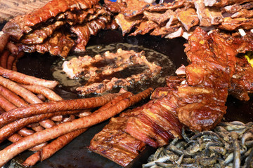 Chef grilling meat during cookout picnic or food event. Meat mix variety, Labour Day, 1 Mai