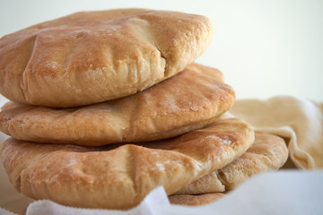 A stack of pita bread on a white background - fresh baked gluten-free pita bread 