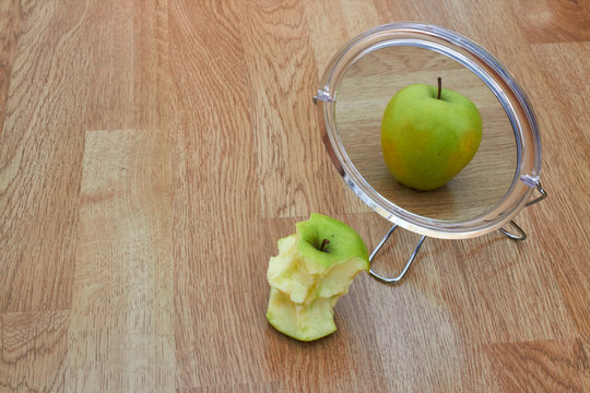 bitten apple reflected in a mirror where this whole anorexia is