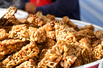 Granola bar in a bowl for sale. Healthy sweet dessert snack. Cereal granola bar with nuts