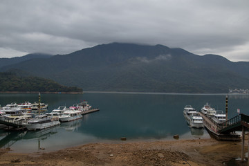 Fototapeta premium Beautiful Sun moon lake with mountain view and reflection of mountain on the water. Taiwan