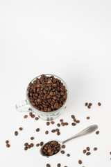 Cup оf coffee ,  cup with roasted coffee beans and a teaspoon on a white background. Isolate. Space for text. Top view