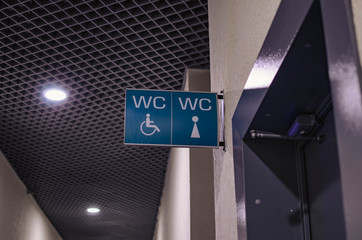 sign about the toilet for men and women in the shopping center