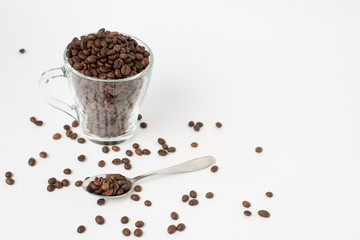 Fototapeta na wymiar Cup оf coffee , cup with roasted coffee beans and a teaspoon on a white background. Isolate. Space for text.