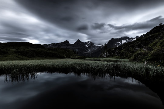 Alpine tarn with dramatic weather