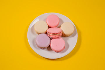 Pink and white macaroons on white plate 