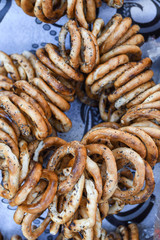 German pretzels stack one over each other, group of thin dry pretzels on rope