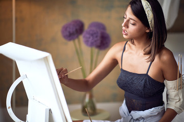young adult female caucasian passionately painting. art, passion concept