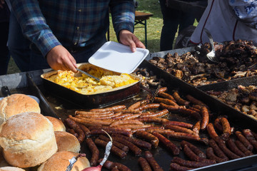 Chef grilling meat during cookout picnic or food event. Meat mix variety, Labour Day, 1 Mai