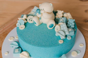 Cake from the pastry chef. Blue cake. Confectioner decorates the cake. Bear cake. 