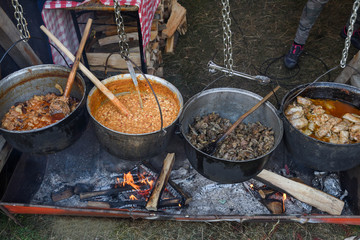 Very large cauldron cooking food during campfire. Cooking in a pot on the fire. Camping concept