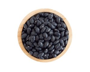Closeup black beans seeds in wooden bowl on white background, healthy food concept