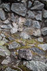 several stones in the foreground. grass and many stones in the background in blur
